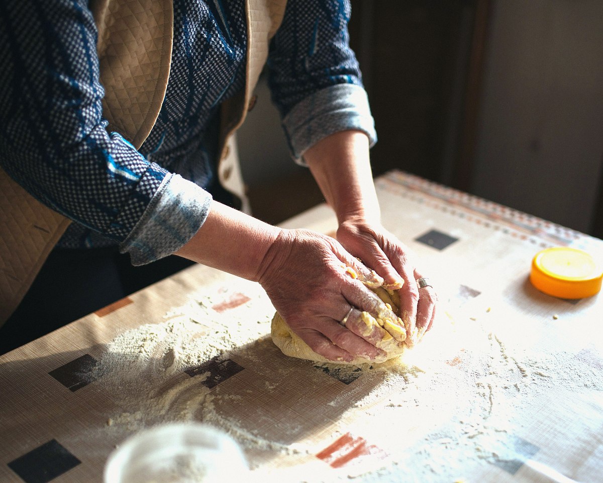 Photographs page and Our story: hands kneading dough, photograph by Shixart1985